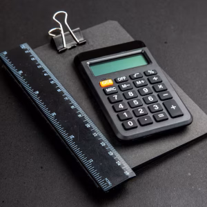 bottom-view-calculator-ruler-notepad-dark-table_140725-144447